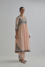 Pink silk Chanderi kurta-dress set with a wavy high-waist and fine gathers. The yoke is fully embroidered with earthy coloured circular appliqué and Aari thread work.