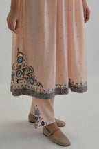Pink silk Chanderi kurta-dress set with a wavy high-waist and fine gathers. The yoke is fully embroidered with earthy coloured circular appliqué and Aari thread work.