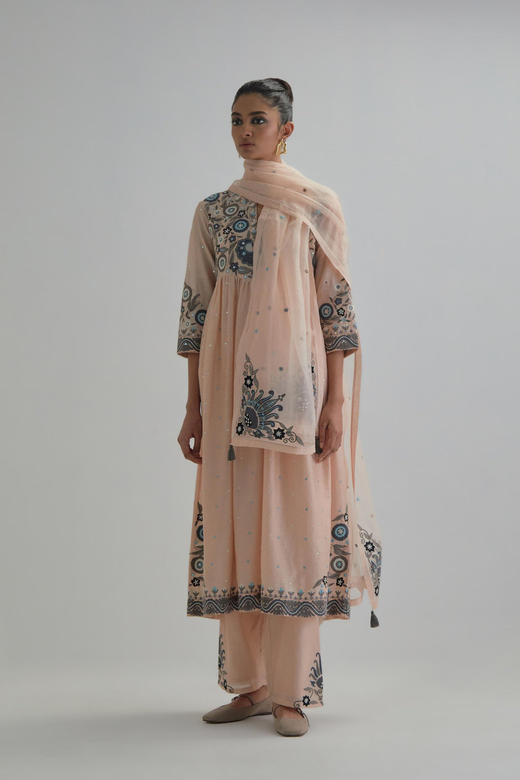 Pink silk Chanderi kurta-dress set with a wavy high-waist and fine gathers. The yoke is fully embroidered with earthy coloured circular appliqué and Aari thread work.