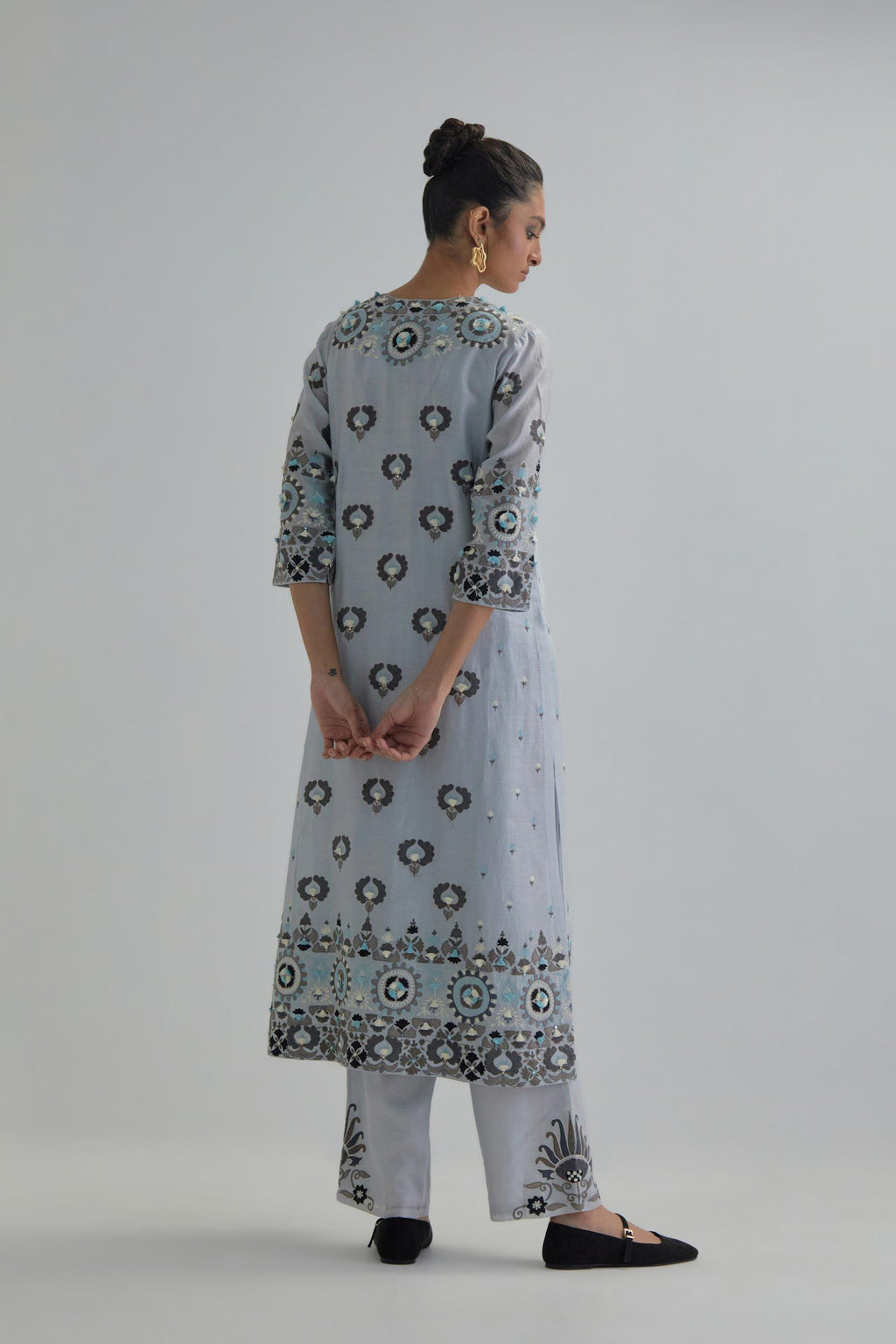 Blue straight kurta, fully embroidered with appliqué flowers, earthy-coloured Aari thread work and silk tassels.