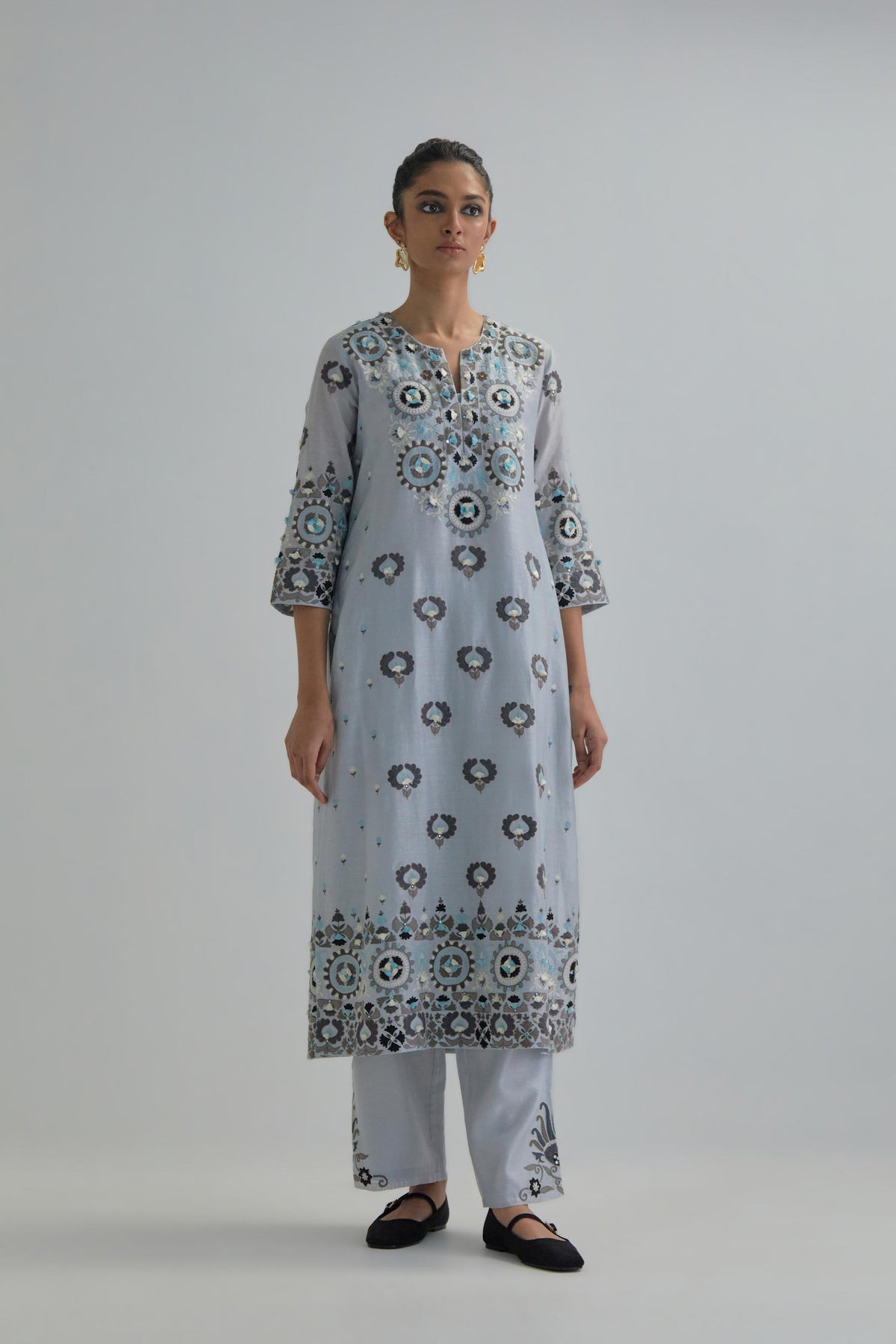 Blue straight kurta, fully embroidered with appliqué flowers, earthy-coloured Aari thread work and silk tassels.