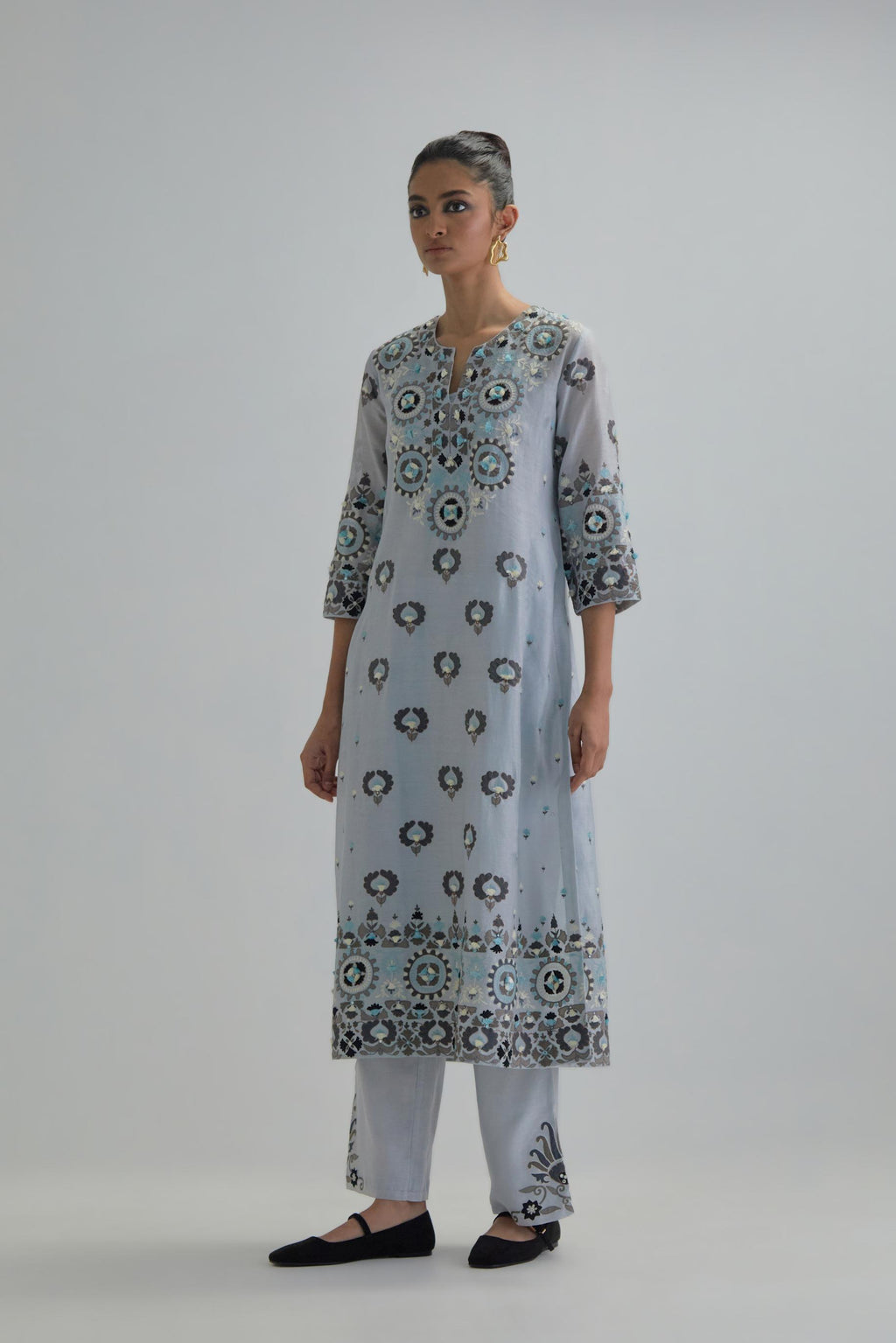 Blue straight kurta, fully embroidered with appliqué flowers, earthy-coloured Aari thread work and silk tassels.