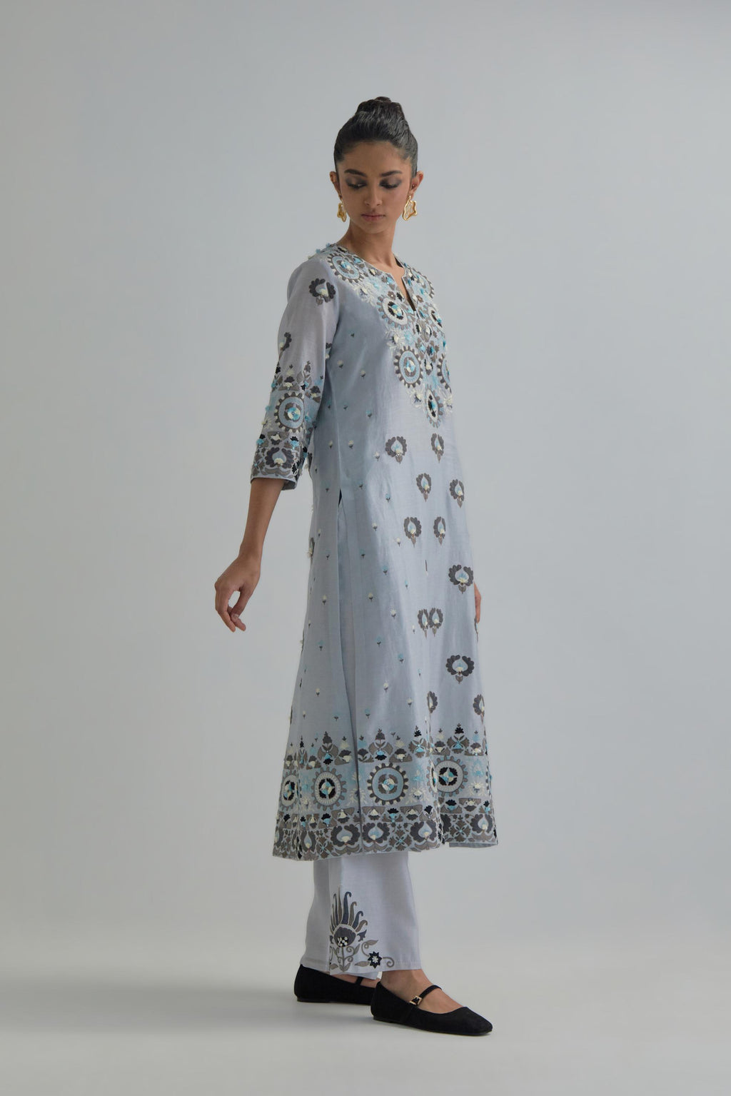 Blue straight kurta, fully embroidered with appliqué flowers, earthy-coloured Aari thread work and silk tassels.