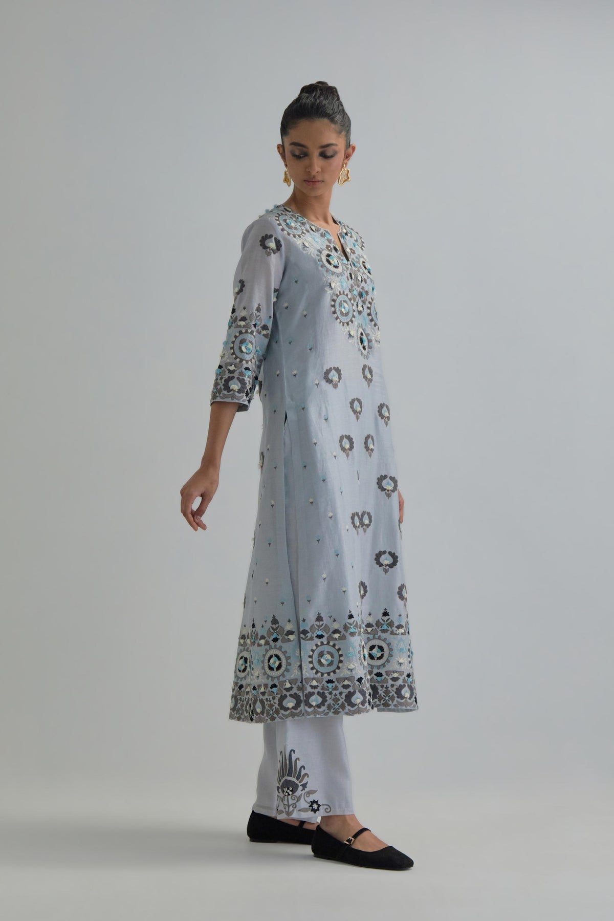 Blue straight kurta, fully embroidered with appliqué flowers, earthy-coloured Aari thread work and silk tassels.