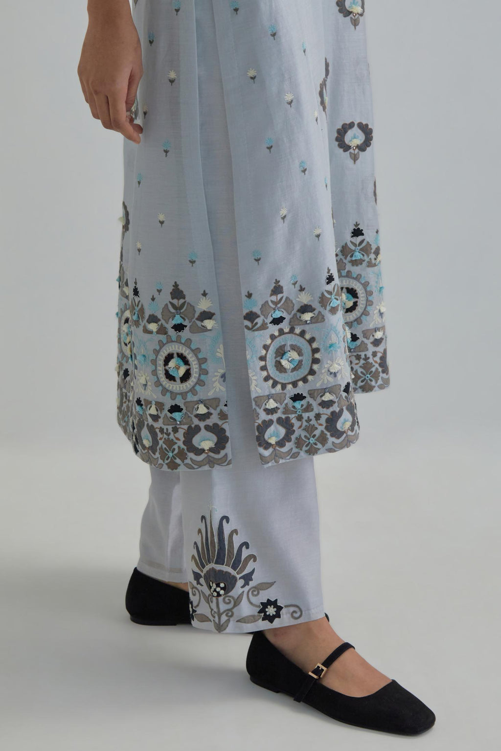 Blue straight kurta, fully embroidered with appliqué flowers, earthy-coloured Aari thread work and silk tassels.