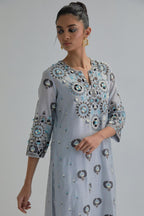 Blue straight kurta, fully embroidered with appliqué flowers, earthy-coloured Aari thread work and silk tassels.