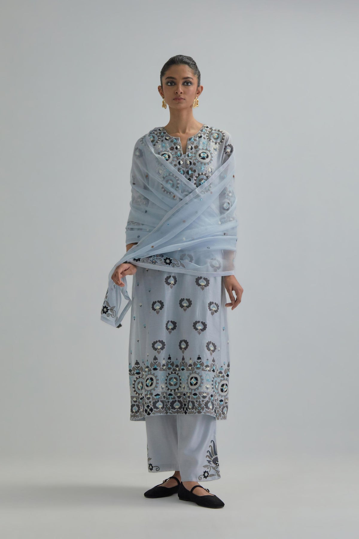 Blue straight kurta, fully embroidered with appliqué flowers, earthy-coloured Aari thread work and silk tassels.
