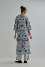 Blue straight kurta set, fully embroidered with bold appliqué flowers, earthy-coloured Aari thread work and silk tassels.