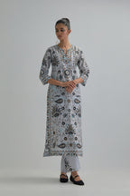 Blue straight kurta set, fully embroidered with bold appliqué flowers, earthy-coloured Aari thread work and silk tassels.