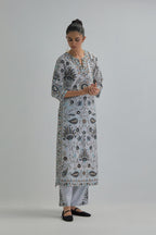 Blue straight kurta set, fully embroidered with bold appliqué flowers, earthy-coloured Aari thread work and silk tassels.