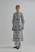 Blue straight kurta set, fully embroidered with bold appliqué flowers, earthy-coloured Aari thread work and silk tassels.