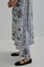 Blue straight kurta set, fully embroidered with bold appliqué flowers, earthy-coloured Aari thread work and silk tassels.