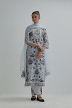 Blue straight kurta set, fully embroidered with bold appliqué flowers, earthy-coloured Aari thread work and silk tassels.
