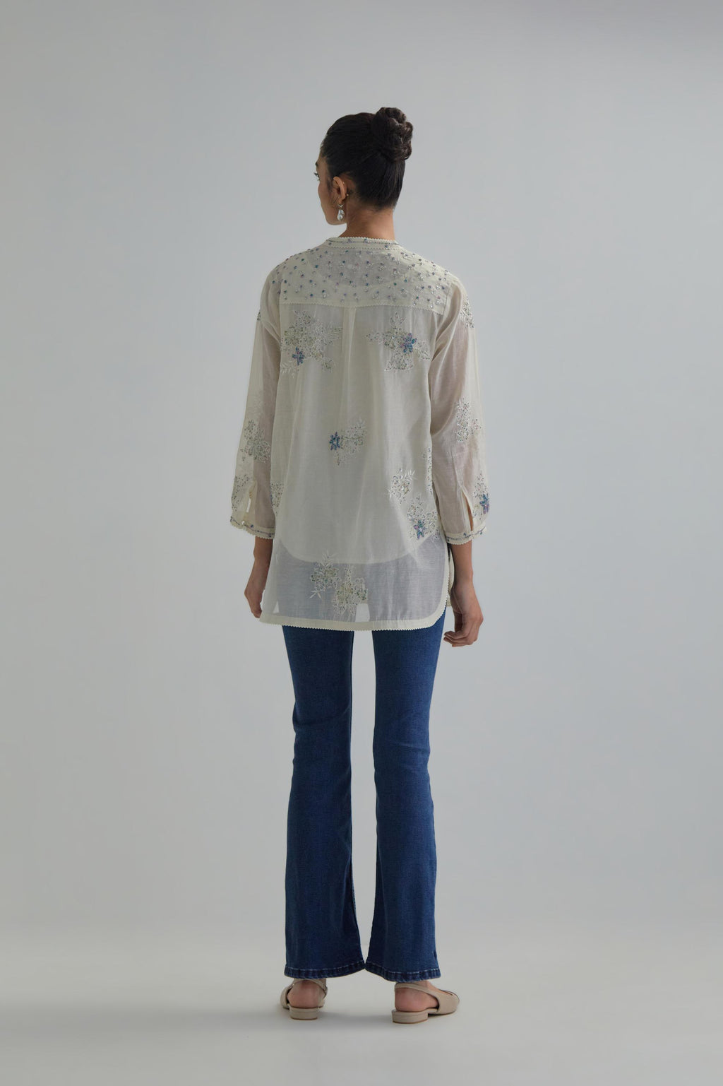 Off white cotton Chanderi top with all-over delicate embroidered blue & beige hand block printed applique flowers, highlighted with sequins and multi coloured beads.