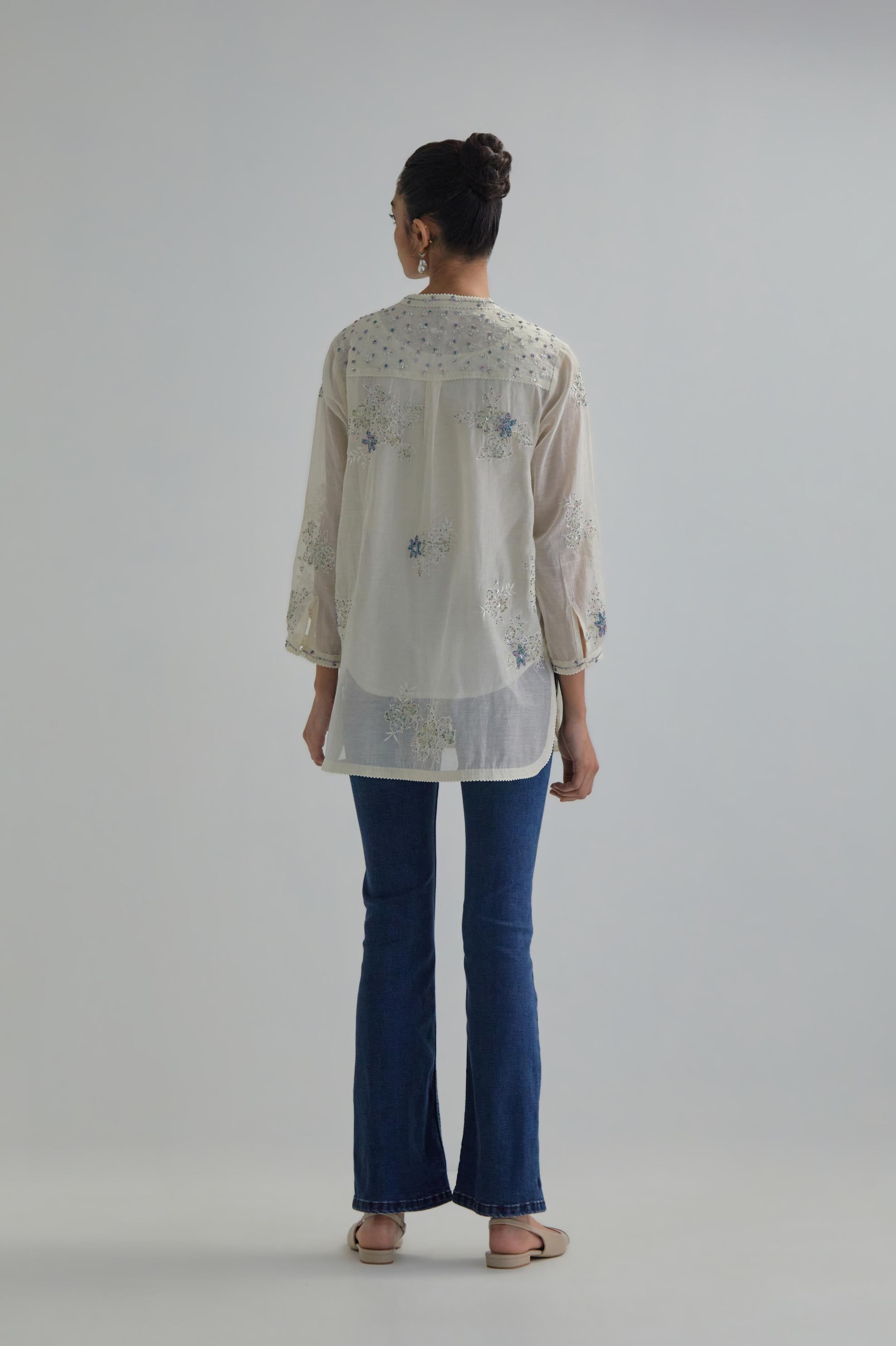 Off white cotton Chanderi top with all-over delicate embroidered blue & beige hand block printed applique flowers, highlighted with sequins and multi coloured beads.