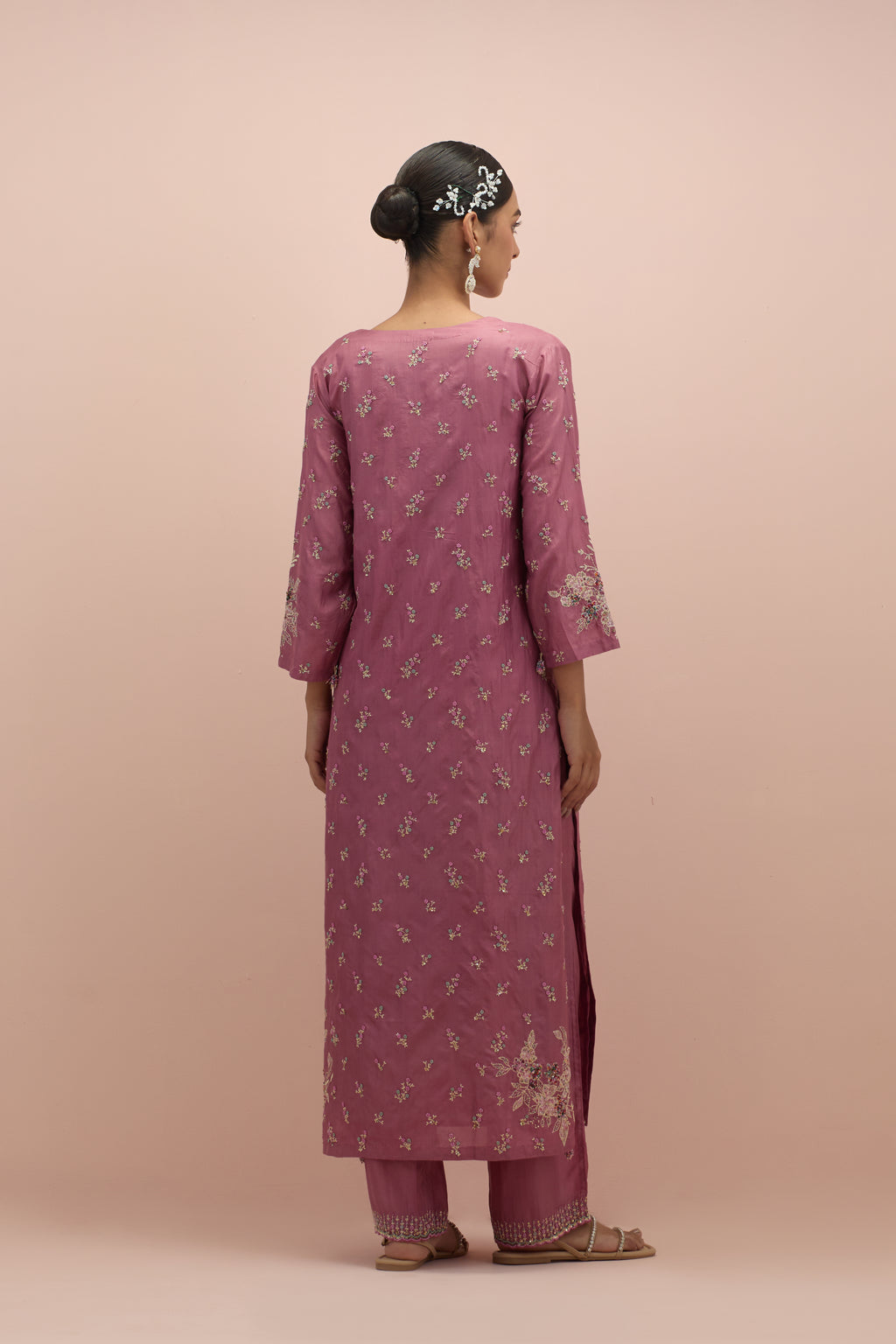 Salmon pink silk straight kurta set with all-over delicate embroidered flowers, highlighted with sequins and multi-colored beads.