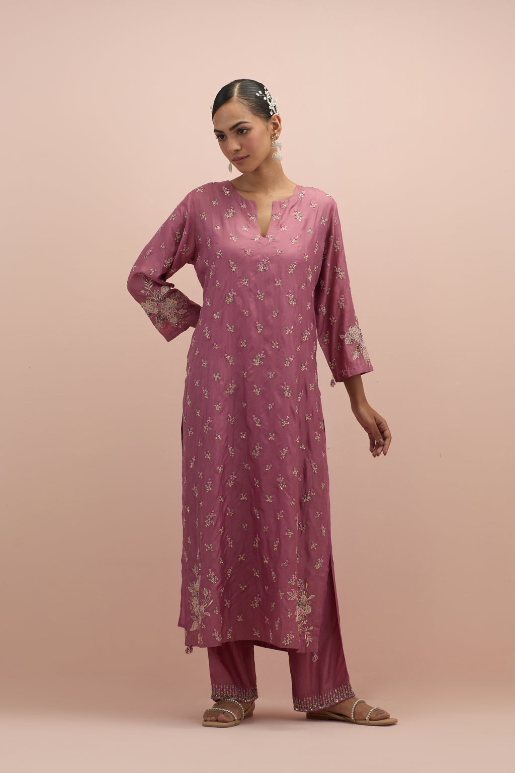 Salmon pink silk straight kurta set with all-over delicate embroidered flowers, highlighted with sequins and multi-colored beads.