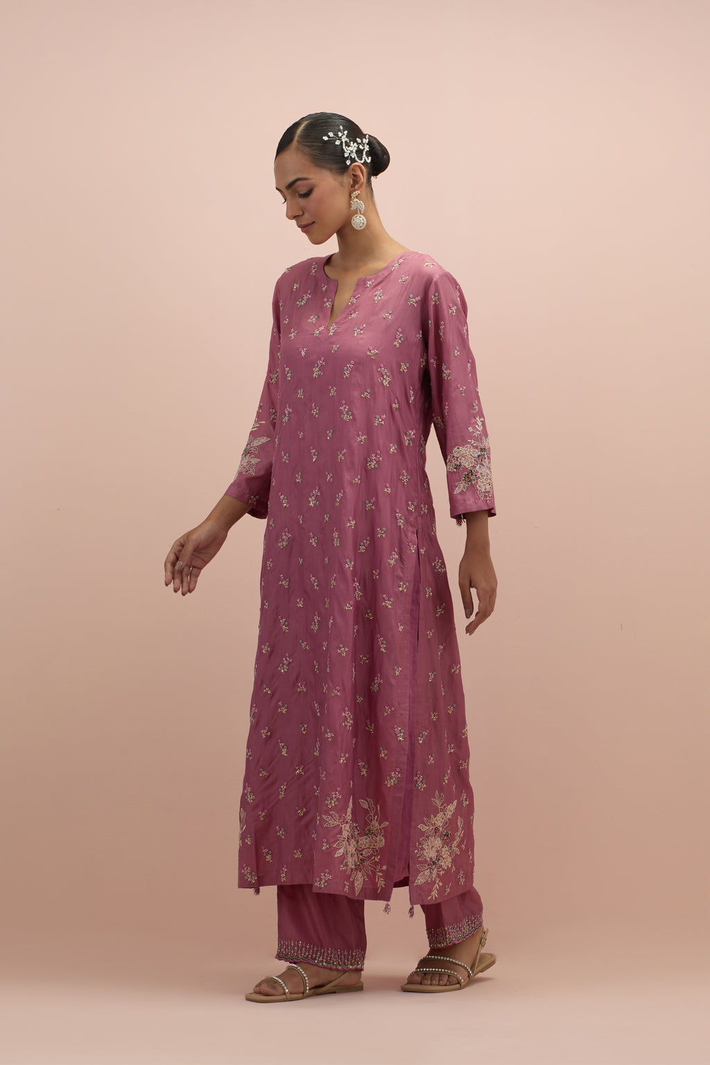 Salmon pink silk straight kurta set with all-over delicate embroidered flowers, highlighted with sequins and multi-colored beads.