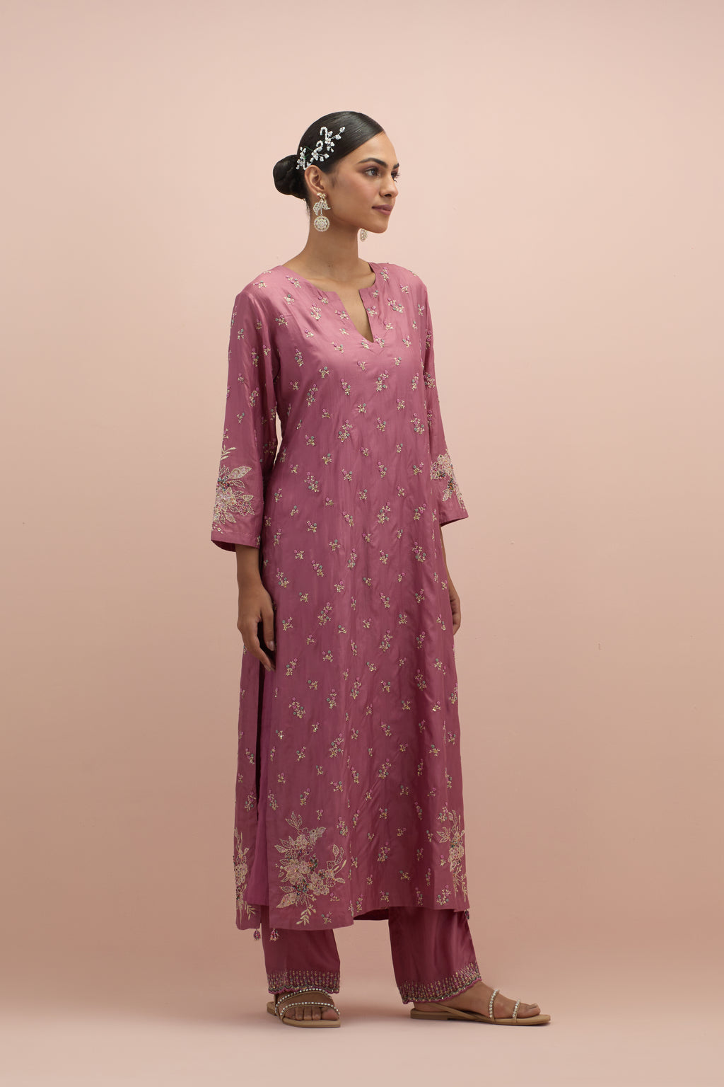 Salmon pink silk straight kurta set with all-over delicate embroidered flowers, highlighted with sequins and multi-colored beads.