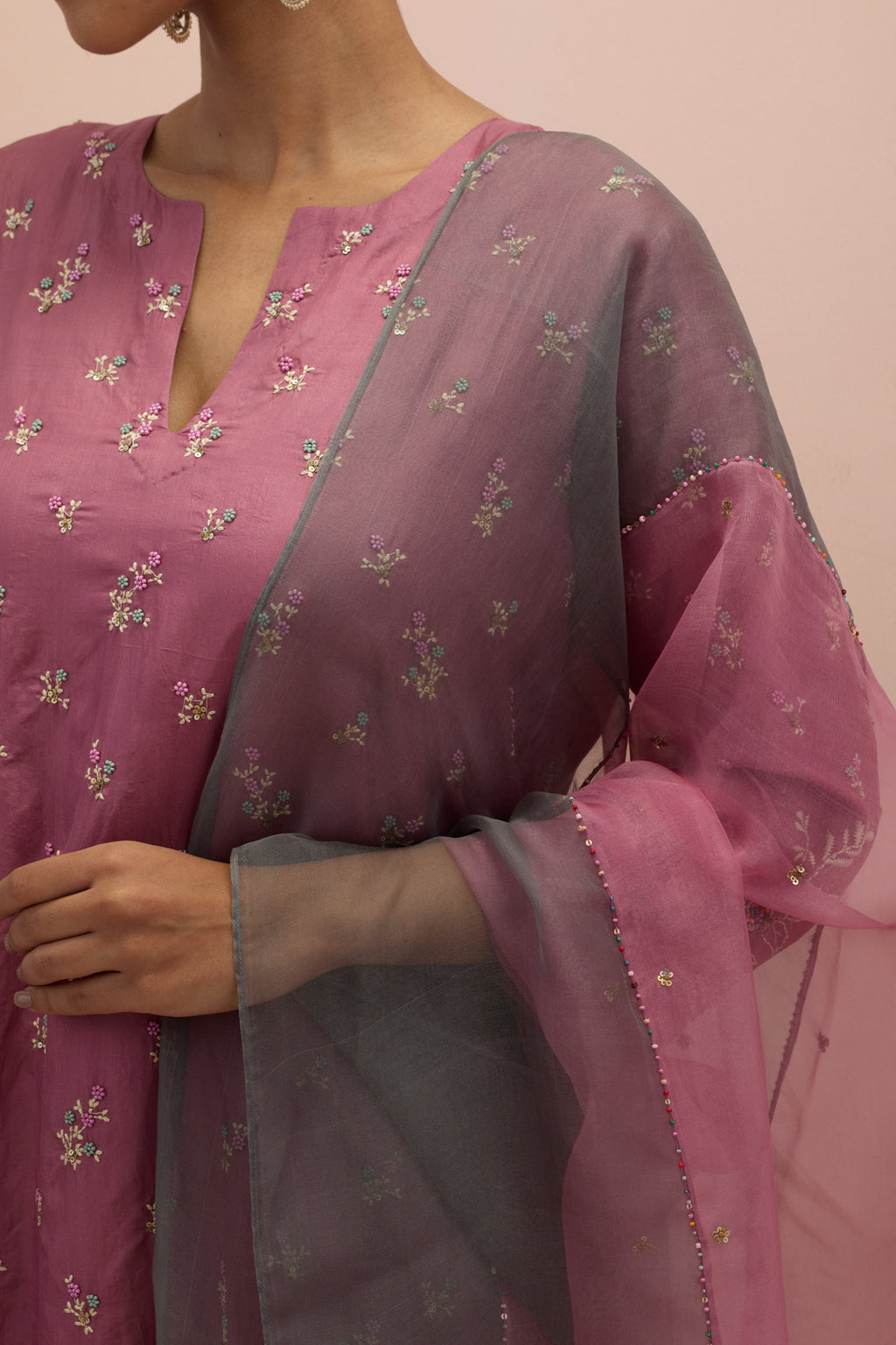 Salmon pink silk straight kurta set with all-over delicate embroidered flowers, highlighted with sequins and multi-colored beads.