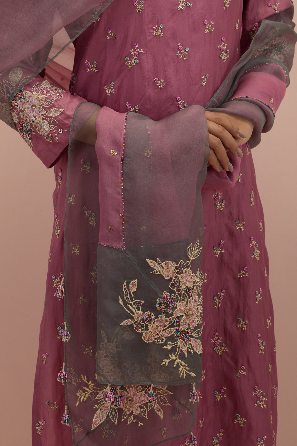 Salmon pink straight kurta set with all-over delicate embroidered flowers, highlighted with sequins and multi-colored beads.