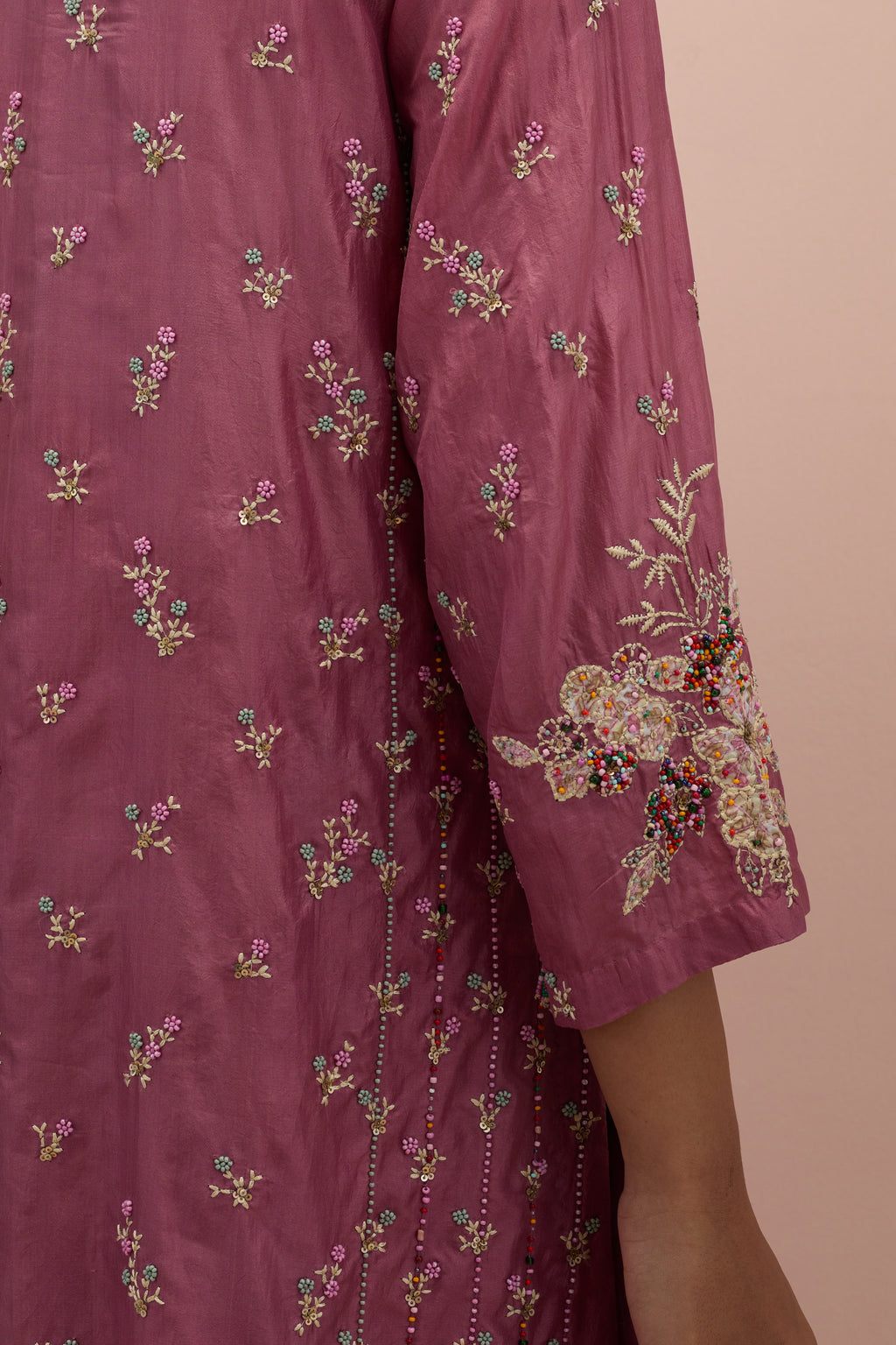 Salmon pink straight kurta set with all-over delicate embroidered flowers, highlighted with sequins and multi-colored beads.