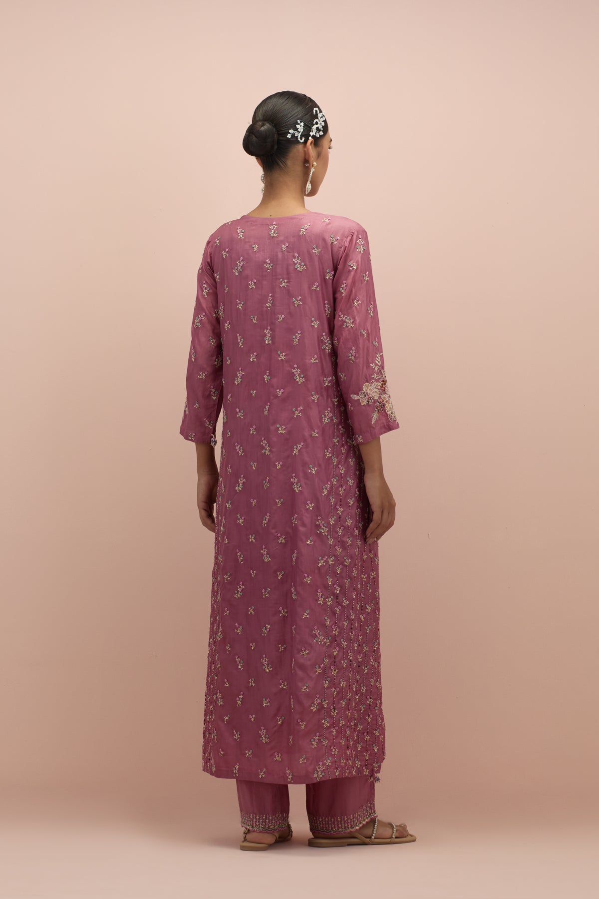 Salmon pink straight kurta set with all-over delicate embroidered flowers, highlighted with sequins and multi-colored beads.