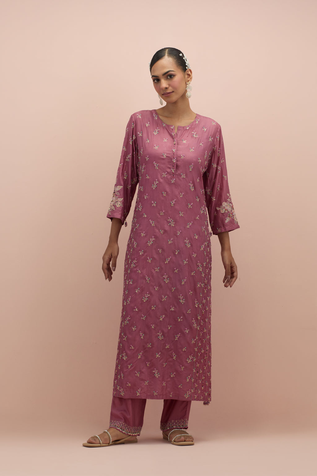 Salmon pink straight kurta set with all-over delicate embroidered flowers, highlighted with sequins and multi-colored beads.