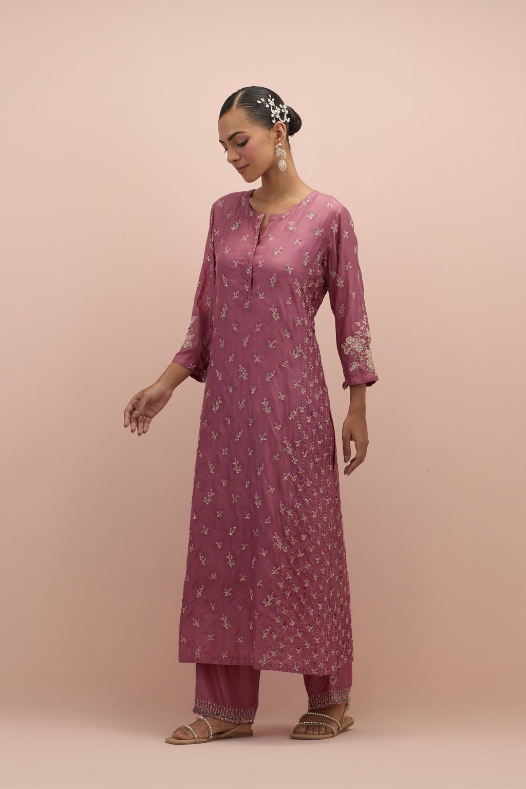 Salmon pink straight kurta set with all-over delicate embroidered flowers, highlighted with sequins and multi-colored beads.