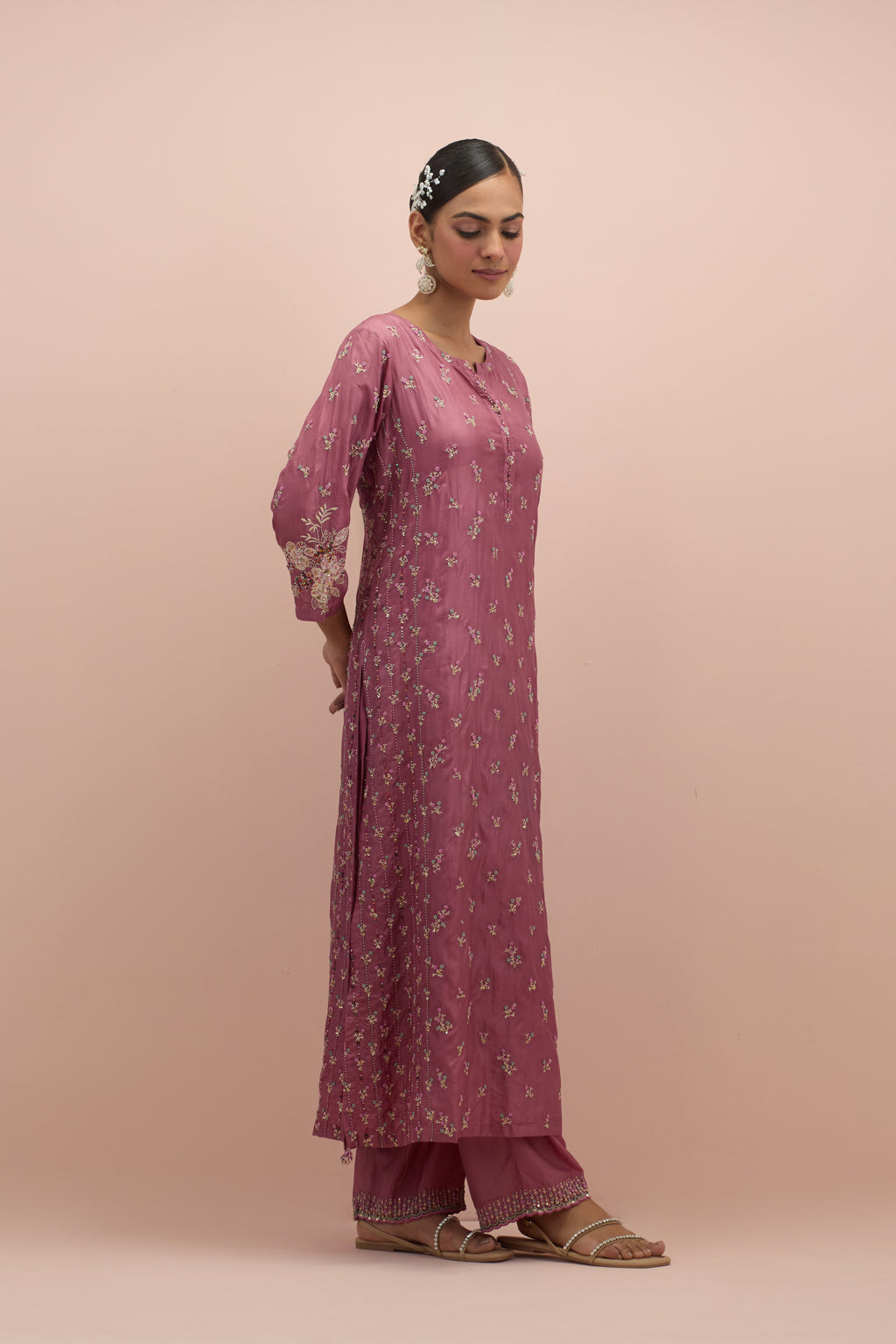 Salmon pink straight kurta set with all-over delicate embroidered flowers, highlighted with sequins and multi-colored beads.