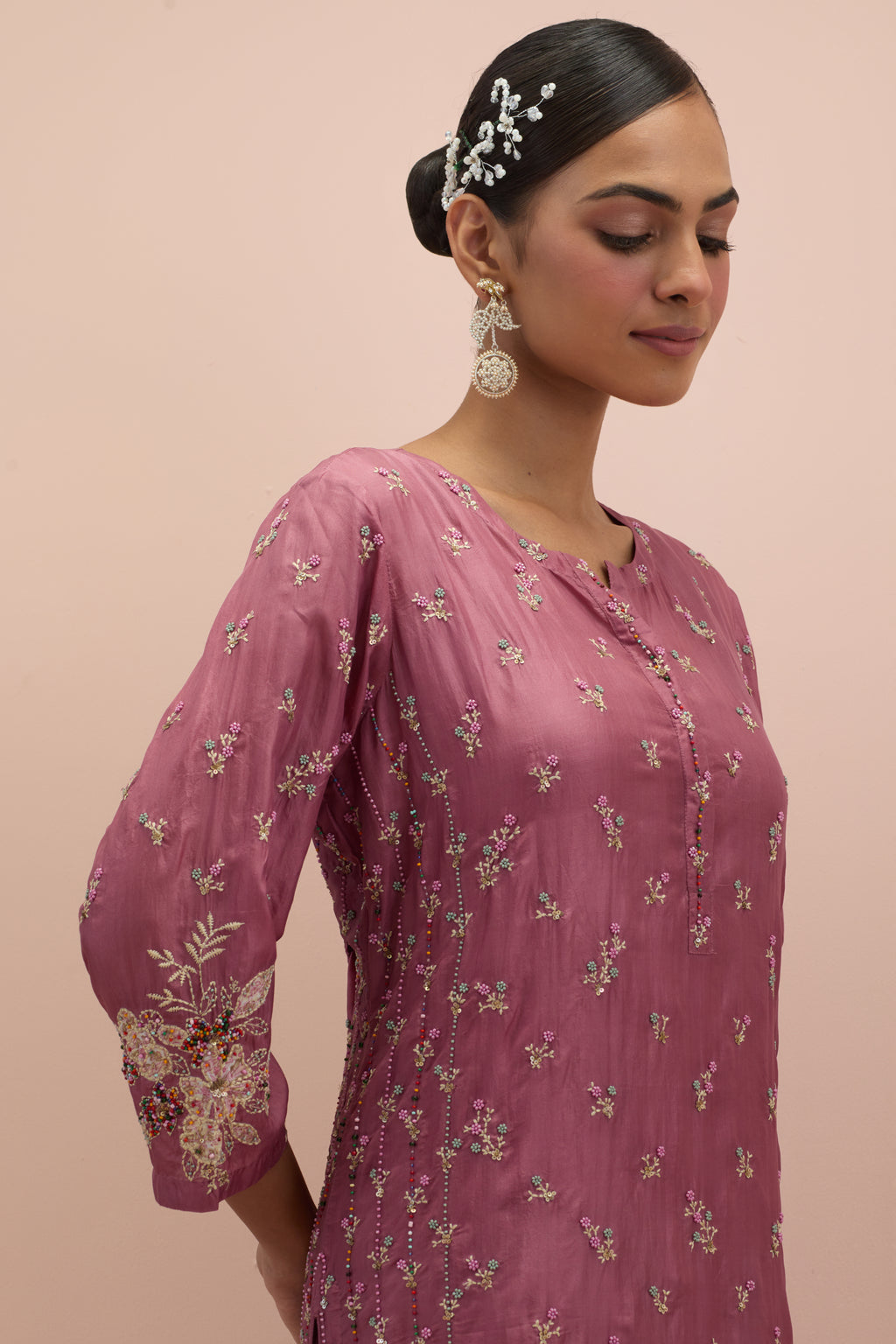 Salmon pink straight kurta set with all-over delicate embroidered flowers, highlighted with sequins and multi-colored beads.