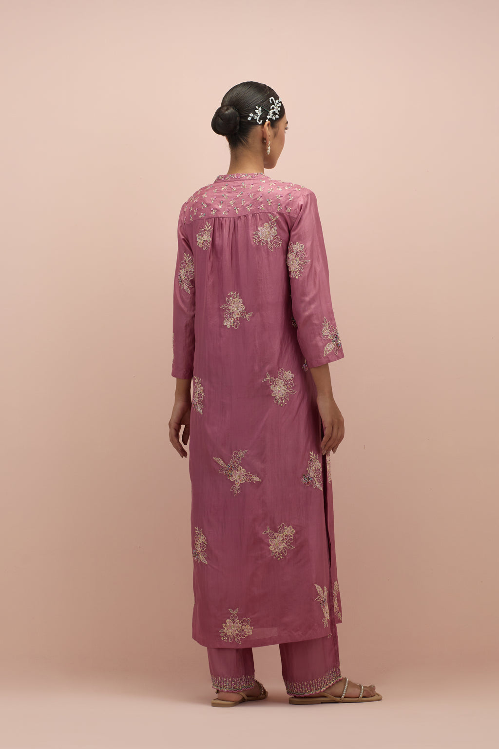 Salmon pink straight kurta set with all-over delicate embroidered flowers, highlighted with sequins and multi-colored beads.