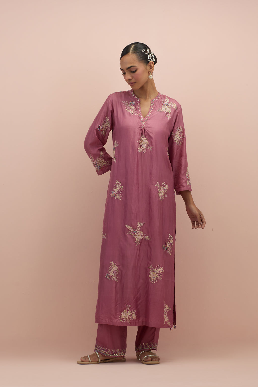 Salmon pink straight kurta set with all-over delicate embroidered flowers, highlighted with sequins and multi-colored beads.