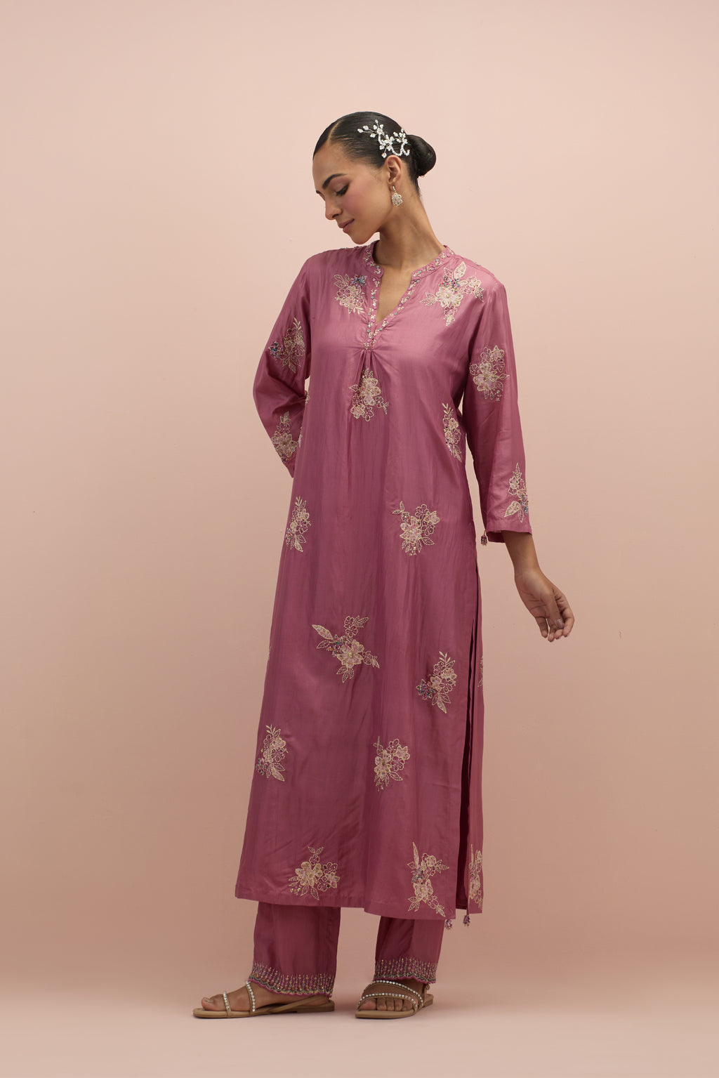 Salmon pink straight kurta set with all-over delicate embroidered flowers, highlighted with sequins and multi-colored beads.