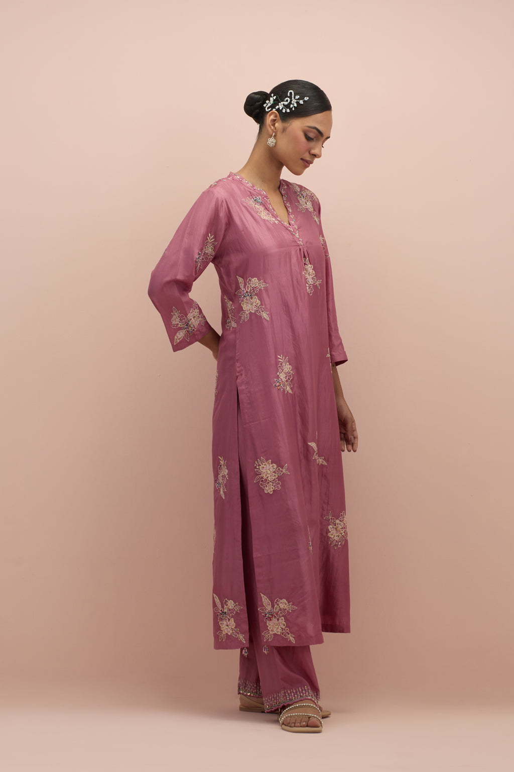 Salmon pink straight kurta set with all-over delicate embroidered flowers, highlighted with sequins and multi-colored beads.