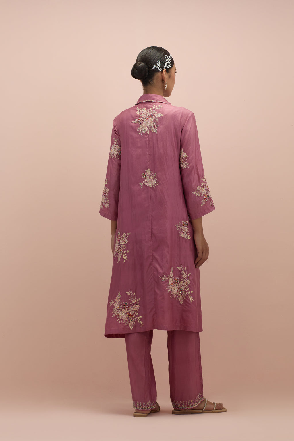 Salmon pink silk short shirt-kurta set with all-over appliqué flowers, highlighted with sequins and multi-colored beads.