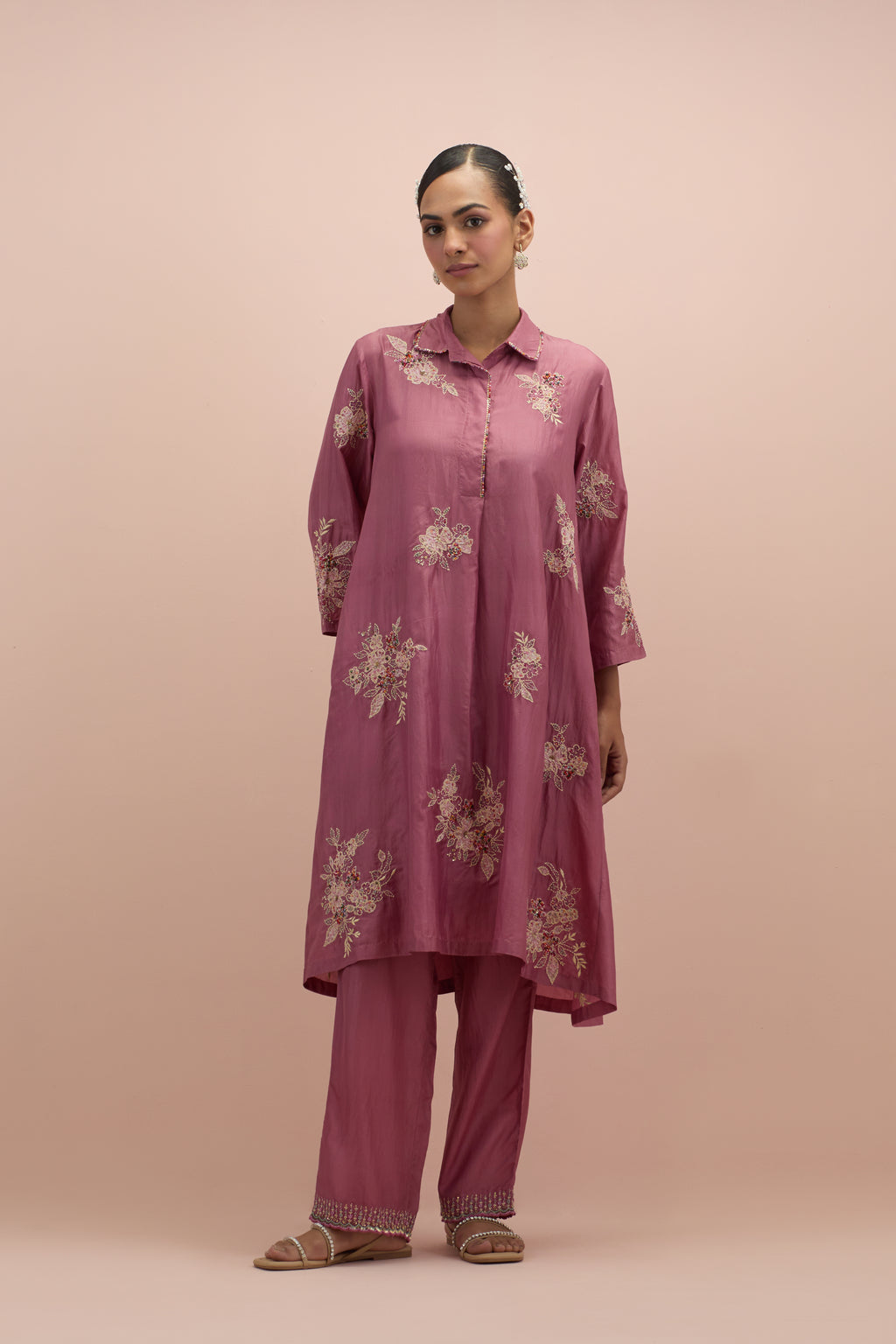 Salmon pink silk short shirt-kurta set with all-over appliqué flowers, highlighted with sequins and multi-colored beads.