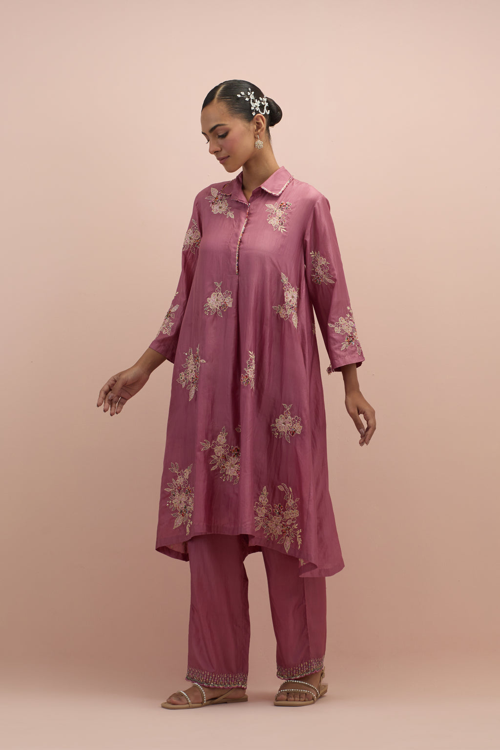 Salmon pink silk short shirt-kurta set with all-over appliqué flowers, highlighted with sequins and multi-colored beads.