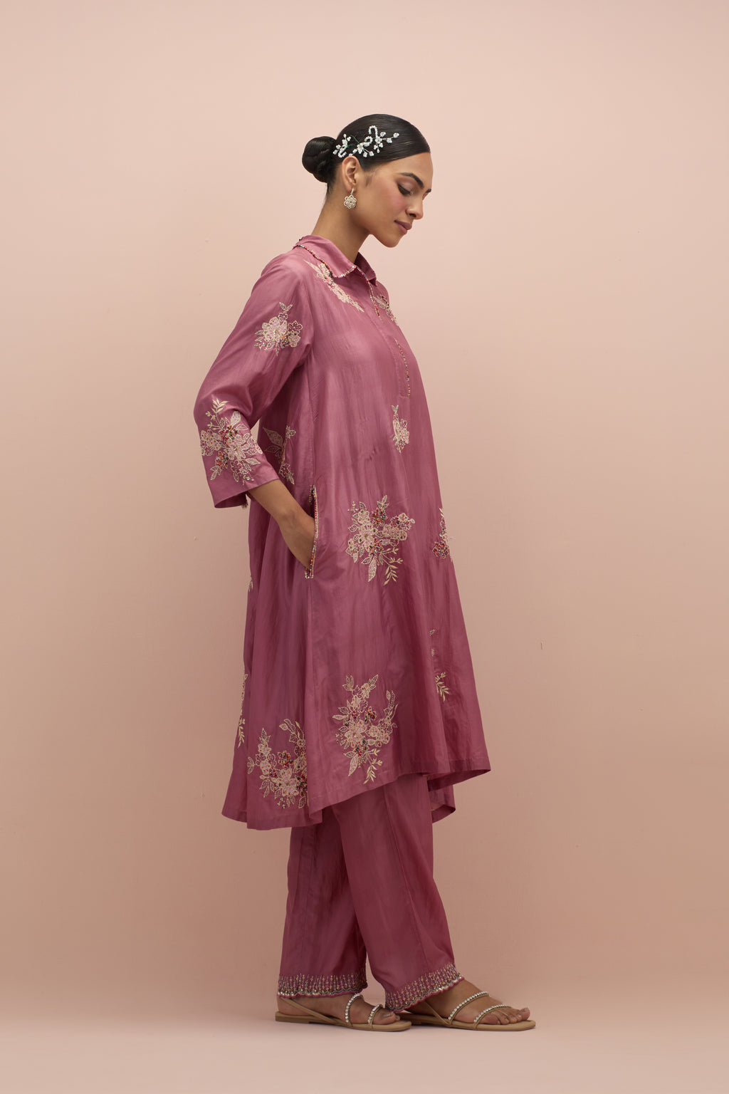 Salmon pink silk short shirt-kurta set with all-over appliqué flowers, highlighted with sequins and multi-colored beads.