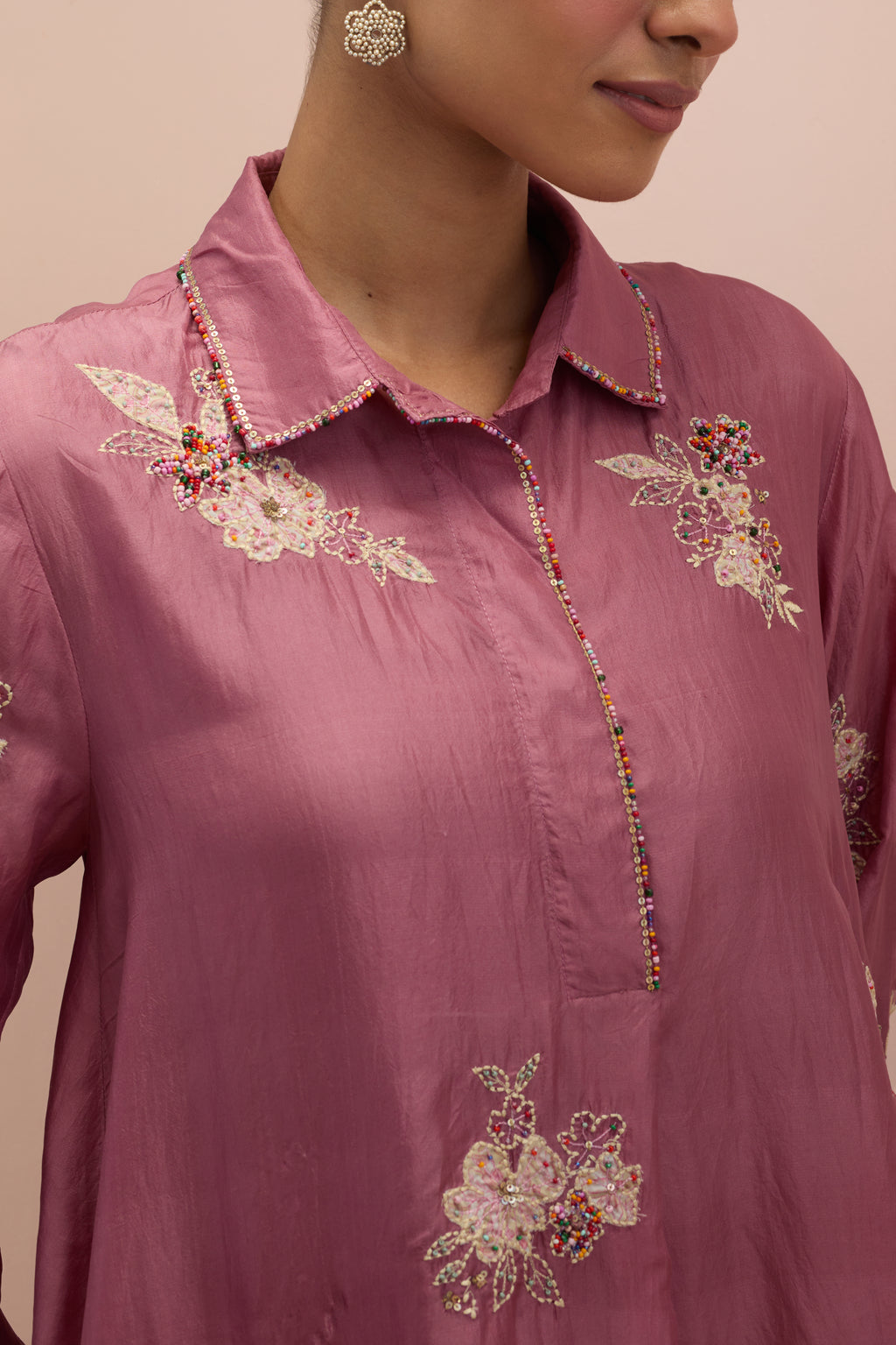 Salmon pink silk short shirt-kurta set with all-over appliqué flowers, highlighted with sequins and multi-colored beads.