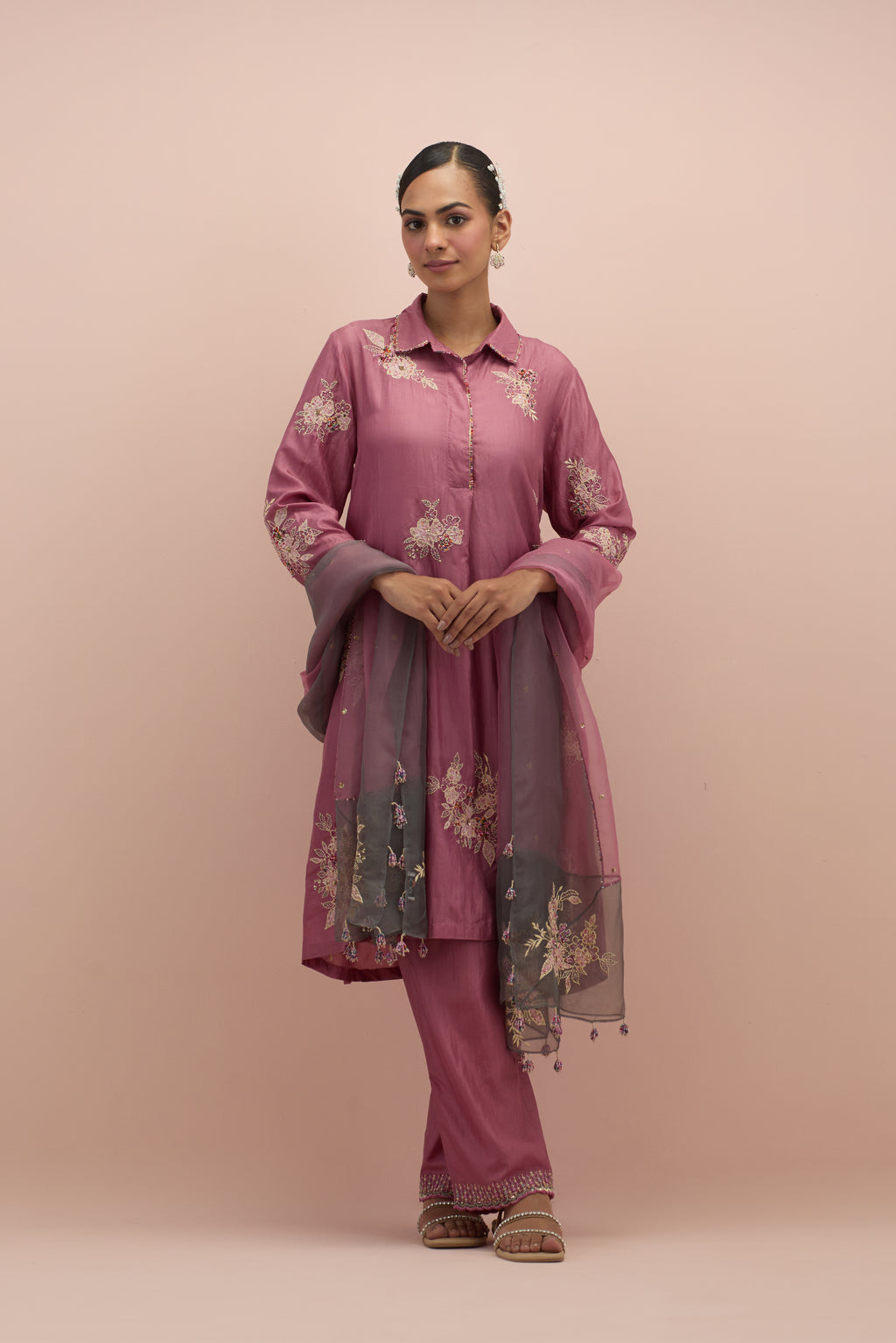 Salmon pink silk short shirt-kurta set with all-over appliqué flowers, highlighted with sequins and multi-colored beads.