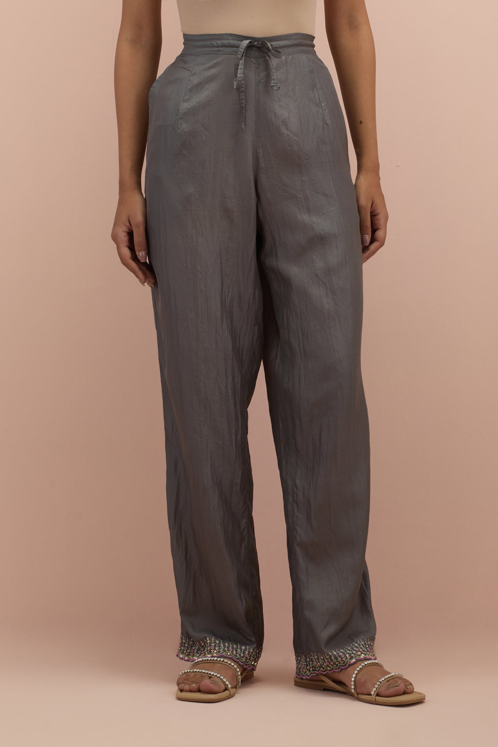 Iron grey silk straight pants with sequins and multi-colored beadwork at hem.