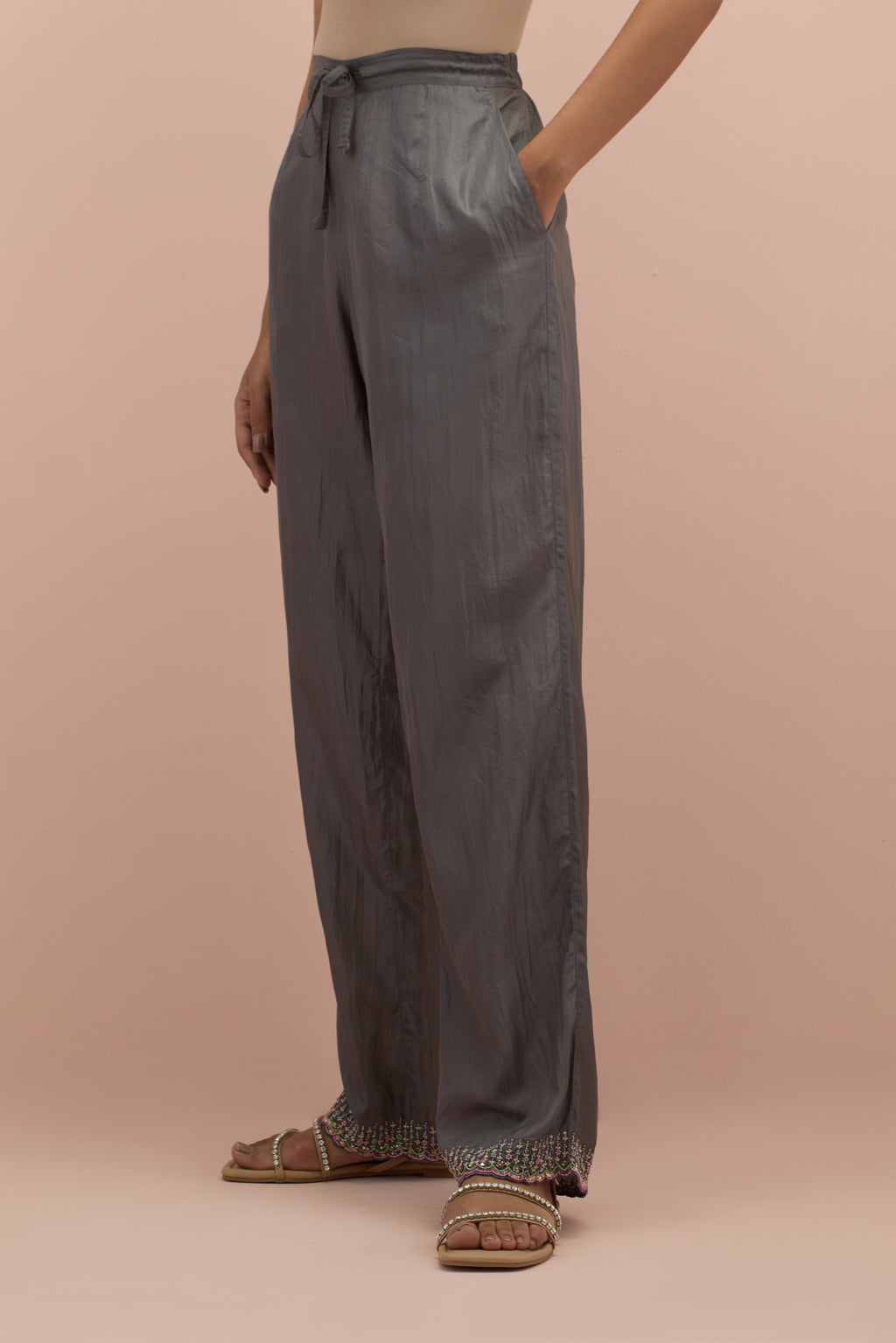 Iron grey silk straight pants with sequins and multi-colored beadwork at hem.