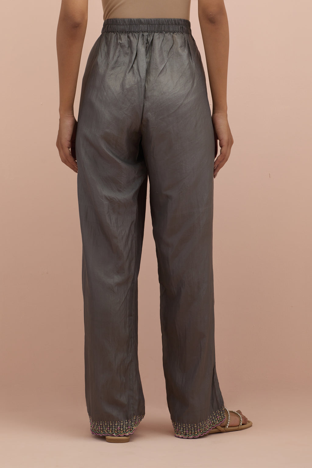 Iron grey silk straight pants with sequins and multi-colored beadwork at hem.