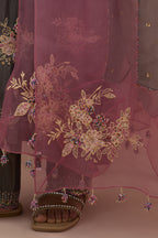 Iron grey silk straight kurta set with randomly placed hand block printed appliquéd flowers, highlighted with sequins and multi-colored beads.