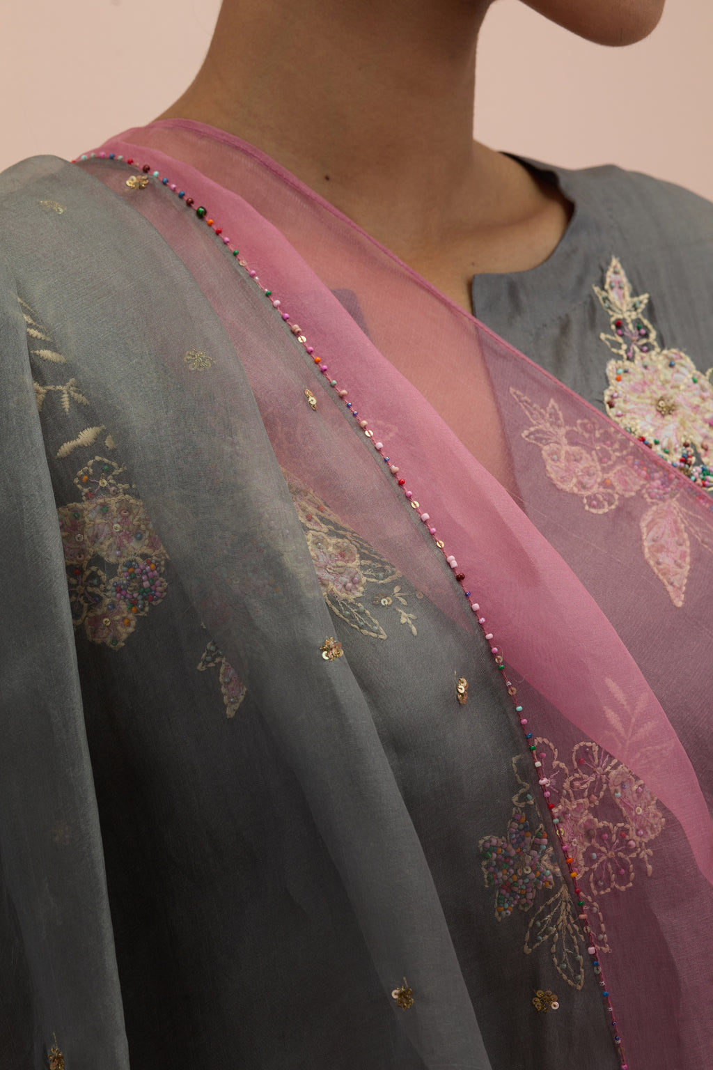 Iron grey & salmon pink silk organza narrow dupatta, highlighted with all-over delicate sequins flower and hand block printed appliqué motifs at dupatta corners.