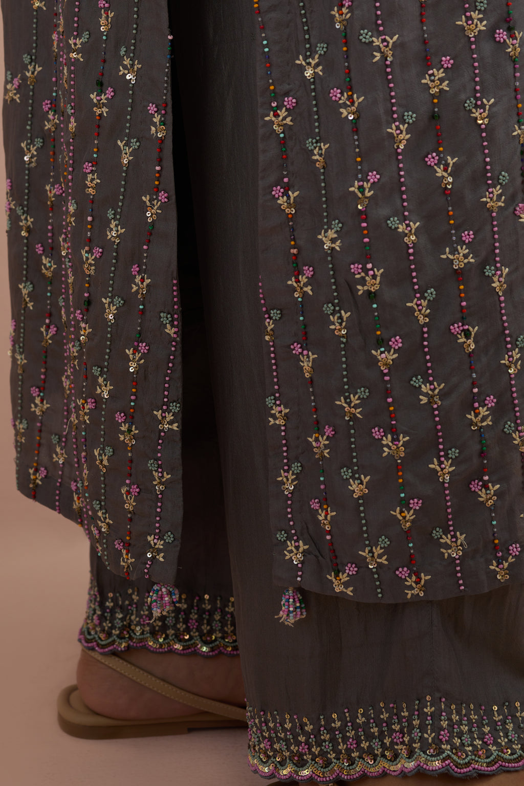 Iron grey straight kurta set with all-over delicate embroidered flowers, highlighted with sequins and multi-colored beads.