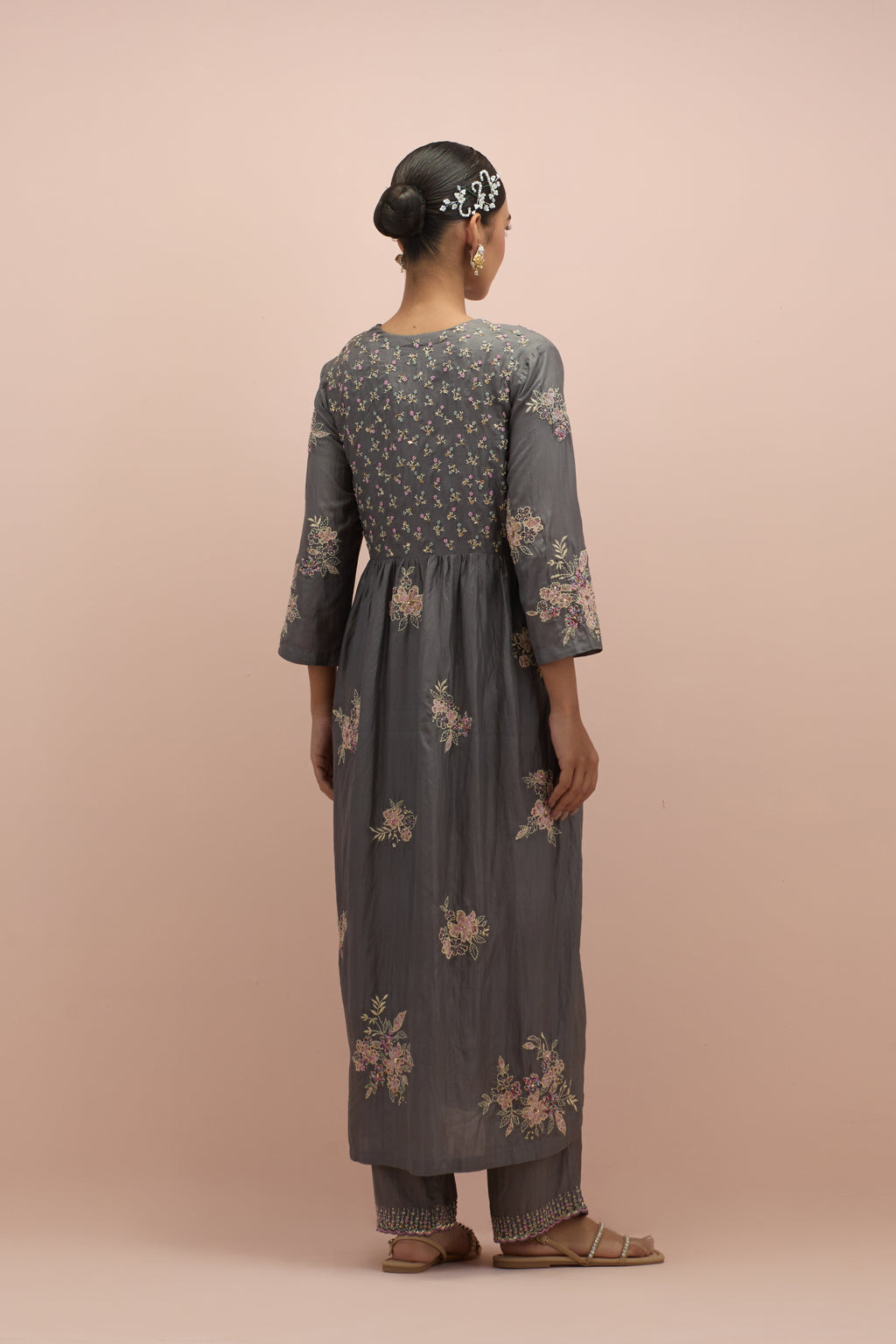 Iron grey silk kurta dress set with delicate embroidered flowers and hand block printed appliqué motifs, highlighted with sequins and multi-colored beads.