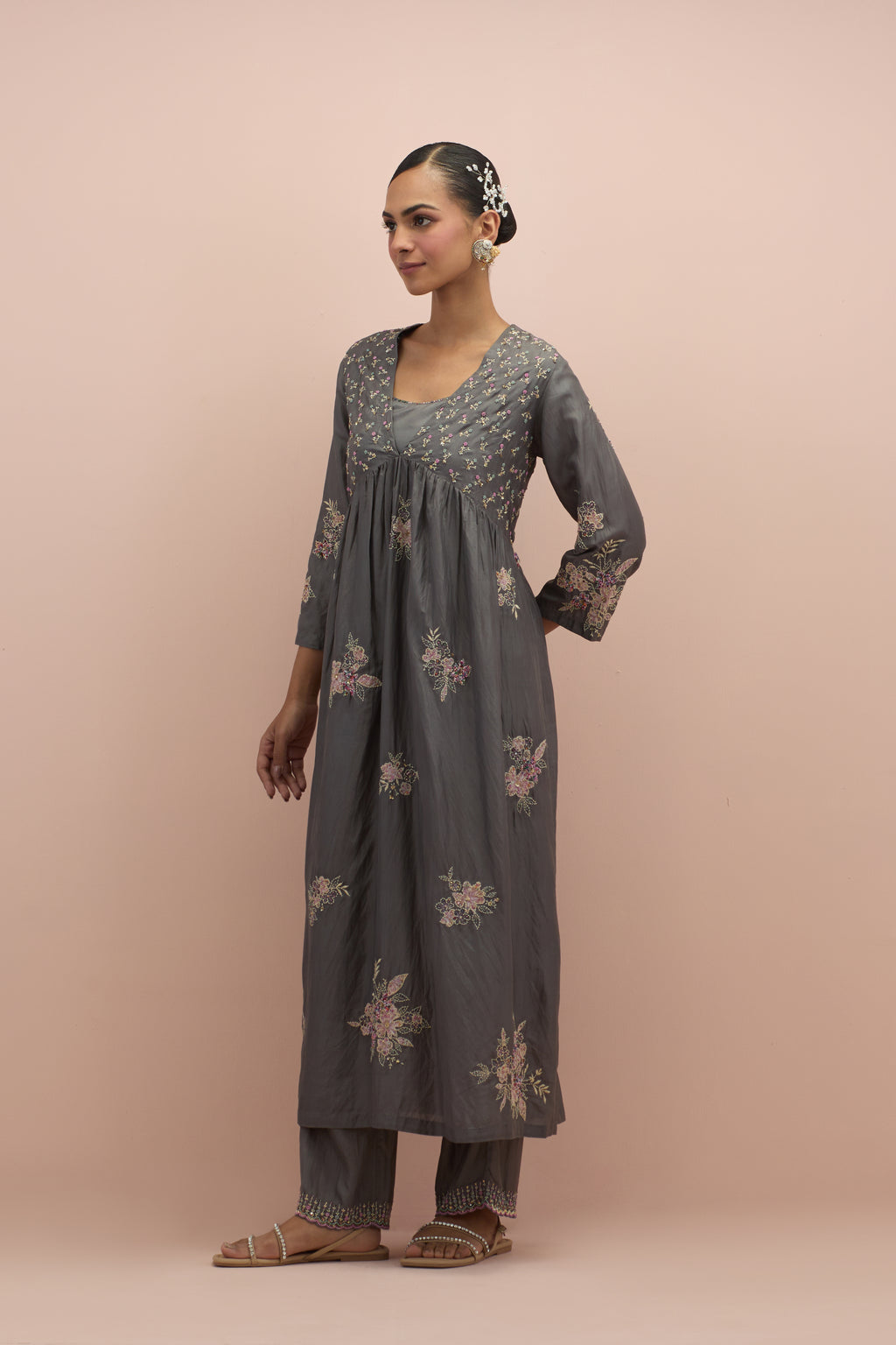 Iron grey silk kurta dress set with delicate embroidered flowers and hand block printed appliqué motifs, highlighted with sequins and multi-colored beads.