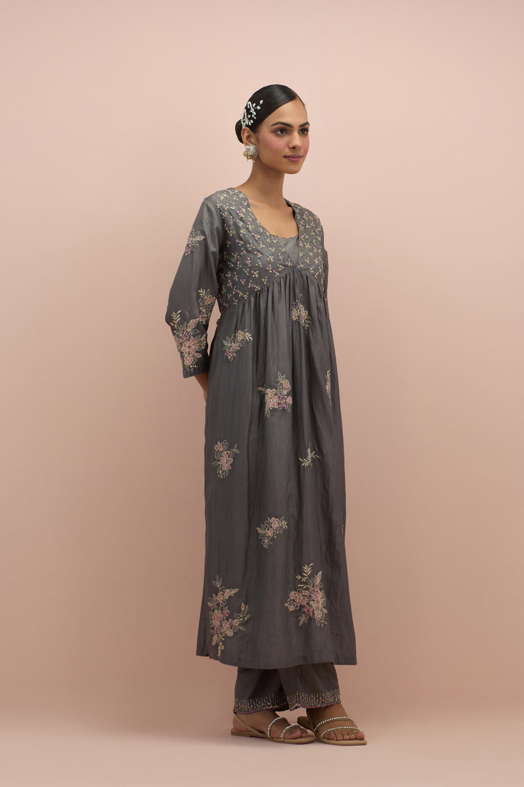 Iron grey silk kurta dress set with delicate embroidered flowers and hand block printed appliqué motifs, highlighted with sequins and multi-colored beads.